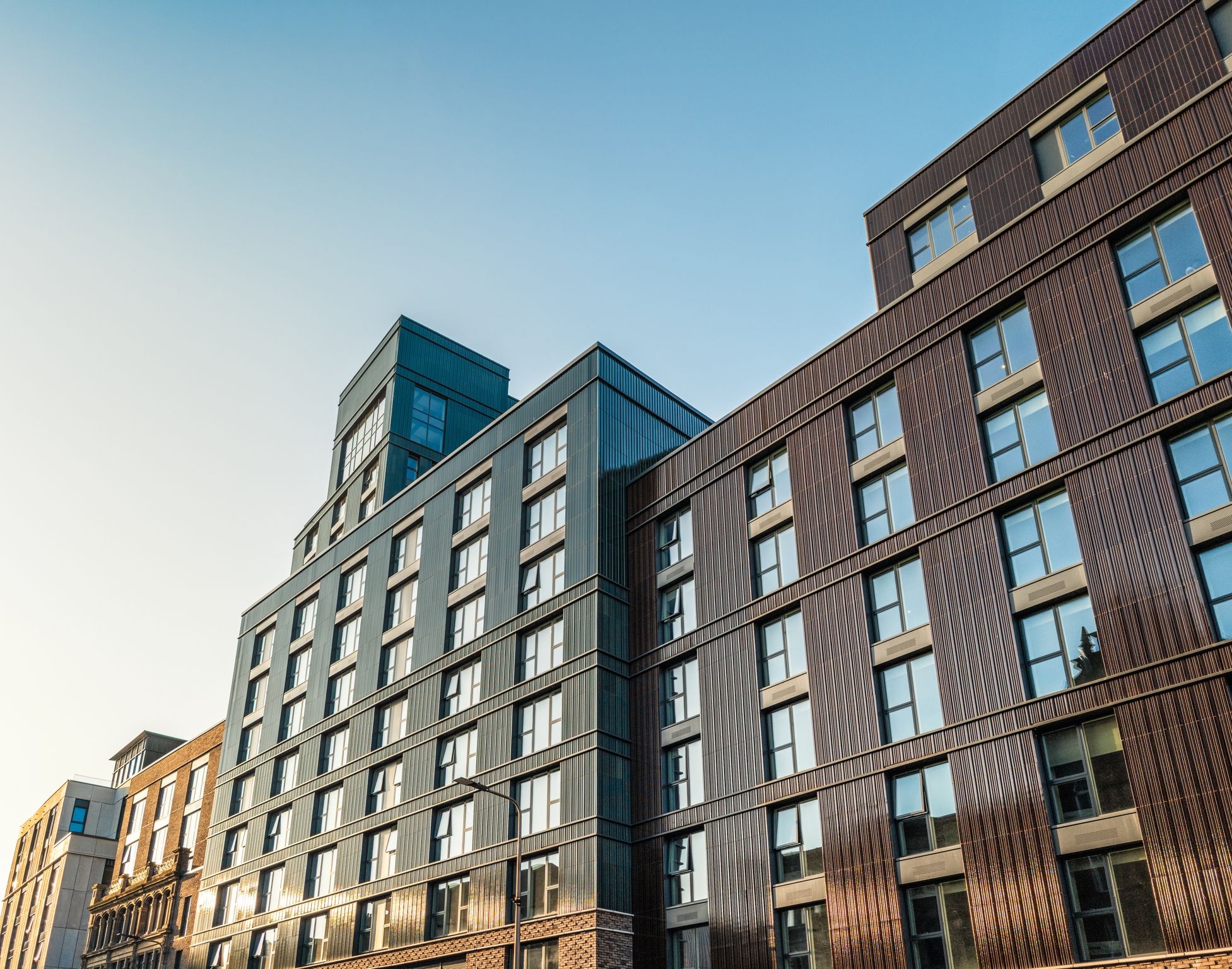 Modern multifamily housing exterior at dusk
